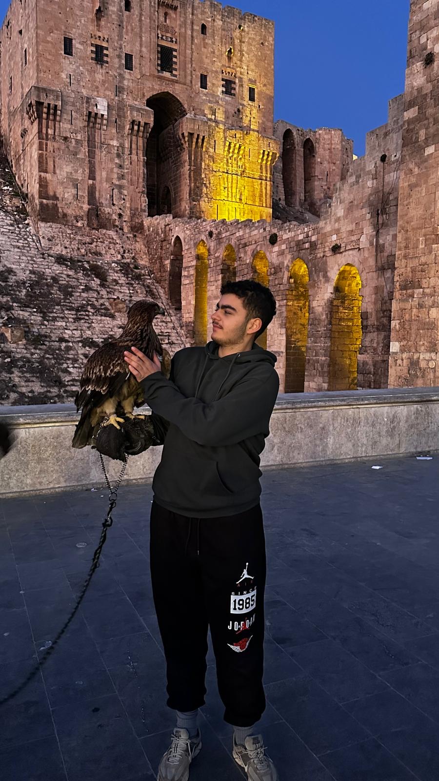 Tarek at the Citadel of Aleppo, Syria, holding an eagle